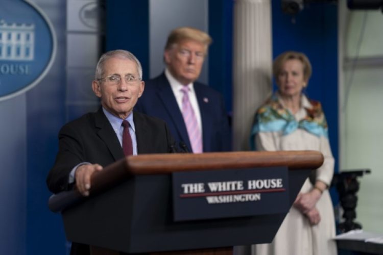 As COVID-19 patient Trump rips off mask, Fauci urges Americans to put it on