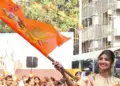 Shilpa waves saffron flag with Lord Ram’s image at Siddhivinayak temple